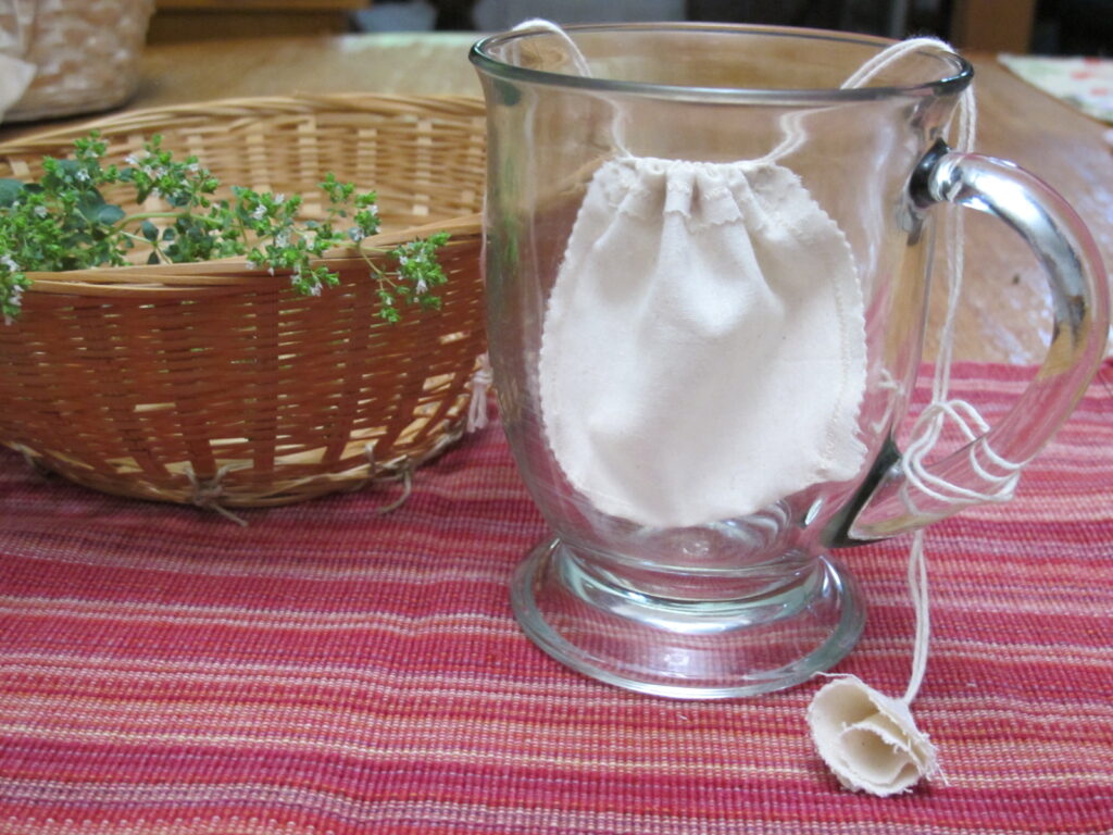 Low Impact Creation's re-usable organic cotton tea bag in a cup.