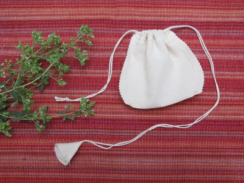 Low Impact Creation's re-usable organic cotton tea bag in cinched view.