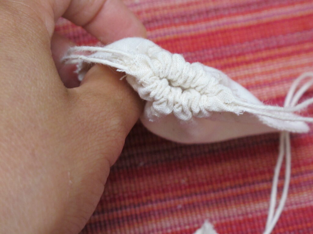 Low Impact Creation's re-usable organic cotton tea bag in cinched view.